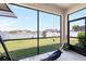 Enclosed patio with lake views, with outdoor seating area and outdoor ceiling fan at 11760 Winterset Cove Dr, Riverview, FL 33579