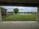 A stunning backyard view featuring a peaceful lake and lush green lawn at 11839 Cross Vine Dr, Riverview, FL 33579