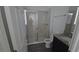 Bathroom featuring glass shower door, granite-topped vanity, modern tile flooring, and a commode at 11839 Cross Vine Dr, Riverview, FL 33579