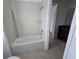 Full bathroom with tiled shower-tub and tiled floors at 11839 Cross Vine Dr, Riverview, FL 33579