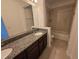 Bathroom with a granite vanity and mirror at 11839 Cross Vine Dr, Riverview, FL 33579