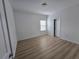 Bright bedroom with hardwood floors, a window, and a white door at 11839 Cross Vine Dr, Riverview, FL 33579