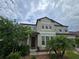 Two-story home featuring a dark front door, neutral stucco exterior and mature landscaping at 11839 Cross Vine Dr, Riverview, FL 33579