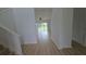 Hallway featuring light-colored wood flooring and views of the bright living space at 11839 Cross Vine Dr, Riverview, FL 33579