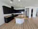 Spacious kitchen with dark cabinets, granite countertops, stainless steel appliances, and a central island at 11839 Cross Vine Dr, Riverview, FL 33579