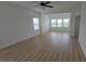 Bright living room with plenty of light, ceiling fan, and beautiful wood floors at 11839 Cross Vine Dr, Riverview, FL 33579
