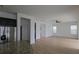 View of an open living room with stainless steel refrigerator, and an adjacent sunny room with lots of windows at 11839 Cross Vine Dr, Riverview, FL 33579