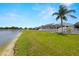 Enjoy a spacious backyard that extends to a tranquil lake at 12008 Fern Blossom Dr, Gibsonton, FL 33534