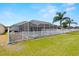 Spacious backyard with screened pool and white picket fence at 12008 Fern Blossom Dr, Gibsonton, FL 33534