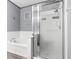 Bathroom showcases a soaking tub, glass enclosed shower, and modern fixtures at 12008 Fern Blossom Dr, Gibsonton, FL 33534