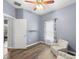 Cozy bedroom with wood-look floors, ceiling fan, and lots of natural light at 12008 Fern Blossom Dr, Gibsonton, FL 33534