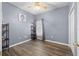 Bedroom with wood-look floors and neutral walls is perfect for relaxation at 12008 Fern Blossom Dr, Gibsonton, FL 33534