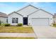 Well-maintained single-Gathering home featuring a two-car garage and manicured front lawn at 12008 Fern Blossom Dr, Gibsonton, FL 33534