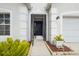 Inviting front entrance with a decorative doorway, landscaped walkway, and accent plants at 12008 Fern Blossom Dr, Gibsonton, FL 33534