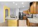 Bright kitchen featuring granite countertops, stainless steel appliances, and ample cabinet space at 12008 Fern Blossom Dr, Gibsonton, FL 33534