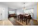 Combined living and dining area with wood floors, natural light, and stylish furnishings at 12008 Fern Blossom Dr, Gibsonton, FL 33534