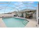 The screened pool is surrounded by an expansive patio, perfect for relaxing at 12008 Fern Blossom Dr, Gibsonton, FL 33534