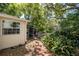 A beautiful backyard featuring lush greenery and a brick walkway at 1211 E Park Cir, Tampa, FL 33604