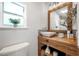 Stylish bathroom with a wood vanity, vessel sink, and decorative mirror at 1211 E Park Cir, Tampa, FL 33604