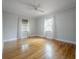 Bright bedroom with hardwood floors, ceiling fan and natural light from windows with curtains at 1211 E Park Cir, Tampa, FL 33604