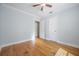 Bedroom featuring light blue walls, hardwood floors, and two white doors at 1211 E Park Cir, Tampa, FL 33604