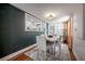 Bright dining room featuring a modern table set, large windows, and hardwood flooring at 1211 E Park Cir, Tampa, FL 33604