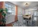 Dining area filled with natural light, featuring stylish curtains and hardwood floors at 1211 E Park Cir, Tampa, FL 33604