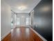 Spacious hallway showcases beautiful hardwood floors, barn door accent, and views into adjoining rooms at 1211 E Park Cir, Tampa, FL 33604
