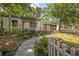 Inviting home with a wooden porch, lush landscaping, and a charming walkway leading to the entrance at 1211 E Park Cir, Tampa, FL 33604