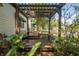 Inviting front porch with pergola, benches, and view of the well-manicured front yard at 1211 E Park Cir, Tampa, FL 33604