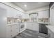 Bright kitchen featuring white cabinets, modern appliances, and a functional layout for easy cooking at 1211 E Park Cir, Tampa, FL 33604