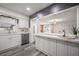 Bright kitchen featuring white cabinets, stainless steel appliances, and an adjacent entertaining space at 1211 E Park Cir, Tampa, FL 33604