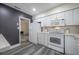 Clean kitchen featuring white appliances, ample counter space, and easy access to the living area at 1211 E Park Cir, Tampa, FL 33604