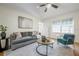 Cozy living room offering a comfortable sofa, stylish decor, and ample natural light at 1211 E Park Cir, Tampa, FL 33604