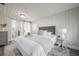 Serene main bedroom featuring neutral tones, wood paneling, and an ensuite bathroom at 1211 E Park Cir, Tampa, FL 33604