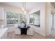 Cozy dining area featuring modern pendant lighting and a view of the screened-in outdoor pool at 12408 Seabrook Dr, Tampa, FL 33626