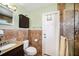 Updated bathroom featuring tiled walls, framed mirror, and a granite vanity at 135 Rodney Ct, Palm Harbor, FL 34684