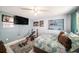Comfortable bedroom with a ceiling fan, natural light, and minimalist decor at 135 Rodney Ct, Palm Harbor, FL 34684