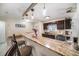 Kitchen featuring granite countertops, a breakfast bar, and dark wood cabinetry at 135 Rodney Ct, Palm Harbor, FL 34684