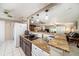 Open kitchen with granite countertops, a breakfast bar, and stainless steel appliances at 135 Rodney Ct, Palm Harbor, FL 34684