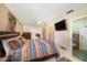 Spacious main bedroom with an en-suite bathroom, ceiling fan, and tile flooring at 135 Rodney Ct, Palm Harbor, FL 34684