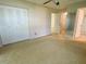 Spacious bedroom with light colored carpet and ample closet space at 1375 Doolittle Ln # 101, Dunedin, FL 34698
