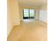 Spacious living room with sliding door to balcony at 1375 Doolittle Ln # 101, Dunedin, FL 34698
