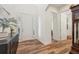 Bright foyer with hardwood floors, a white front door with sidelights, and decorative molding for an elegant look at 14319 Rolling Dune Rd, Lithia, FL 33547