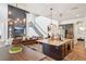 Open-concept kitchen and living area with granite counters and wood floors at 14319 Rolling Dune Rd, Lithia, FL 33547