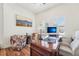 Functional home office with dark hardwood floors, plantation shutters, a computer, and ample desk space at 14319 Rolling Dune Rd, Lithia, FL 33547