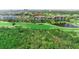 Scenic aerial shot of the condo building with golf course and lush greenery, creating a peaceful setting at 14820 Rue De Bayonne # 208, Clearwater, FL 33762