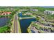 Scenic aerial view of waterfront condos with parking, lush landscaping, and community pool at 14820 Rue De Bayonne # 208, Clearwater, FL 33762