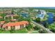 Beautiful aerial view of condos, lake, and landscaping on a beautiful sunny day at 14820 Rue De Bayonne # 208, Clearwater, FL 33762