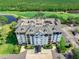 Overhead view of the condo building highlighting its meticulous landscaping and proximity to lush green spaces at 14820 Rue De Bayonne # 208, Clearwater, FL 33762